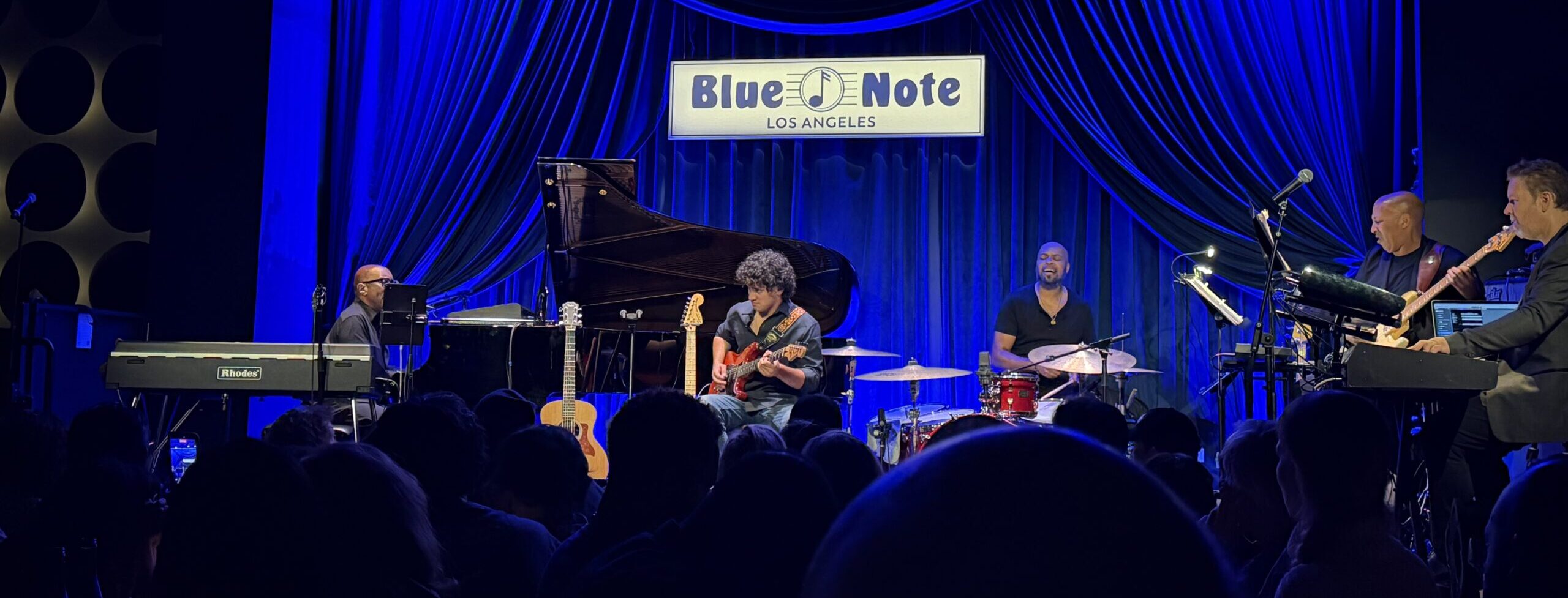 Greg Phillinganes and band performing live at Blue Note Los Angeles under blue stage lighting